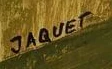 Signature 5 — Alice Jaquet · En bas à gauche, sur le fond ocre, près de l’épaule.